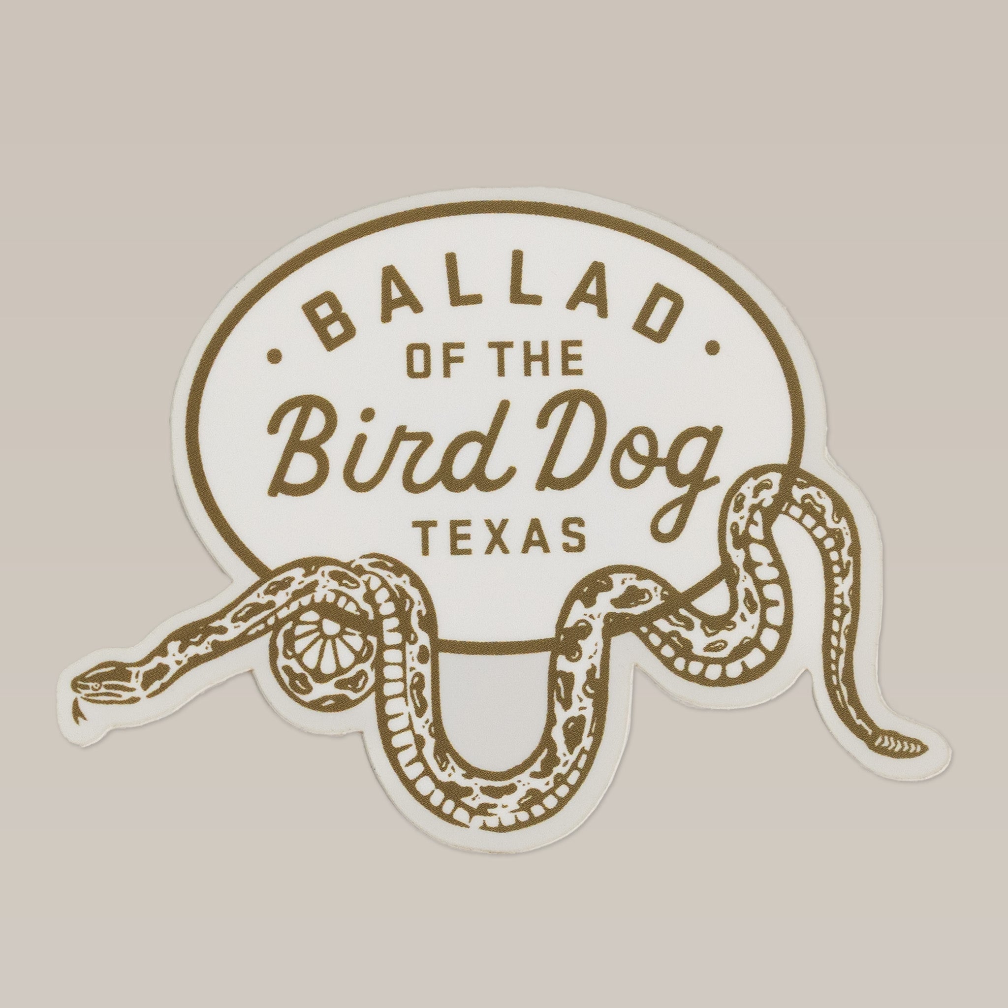The Ballad of the Bird Dog Shop Sticker features a rattlesnake oval wrap design and "Ballad of the Bird Dog Texas" text, inspired by the Desert Series.