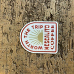 A "Shop Stickers | Mescalito Coffee" sticker by Mescalito Coffee features a sunburst design and the phrase "WORTH THE TRIP MESCALITO COFFEE," ideal for fans of small town cafés and unique designs.
