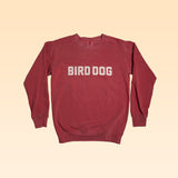 The Ballad of the Bird Dog Shop Sweater | Bird Dog Honor features "BIRD DOG" in bold white letters on the front, shown against a beige gradient background.