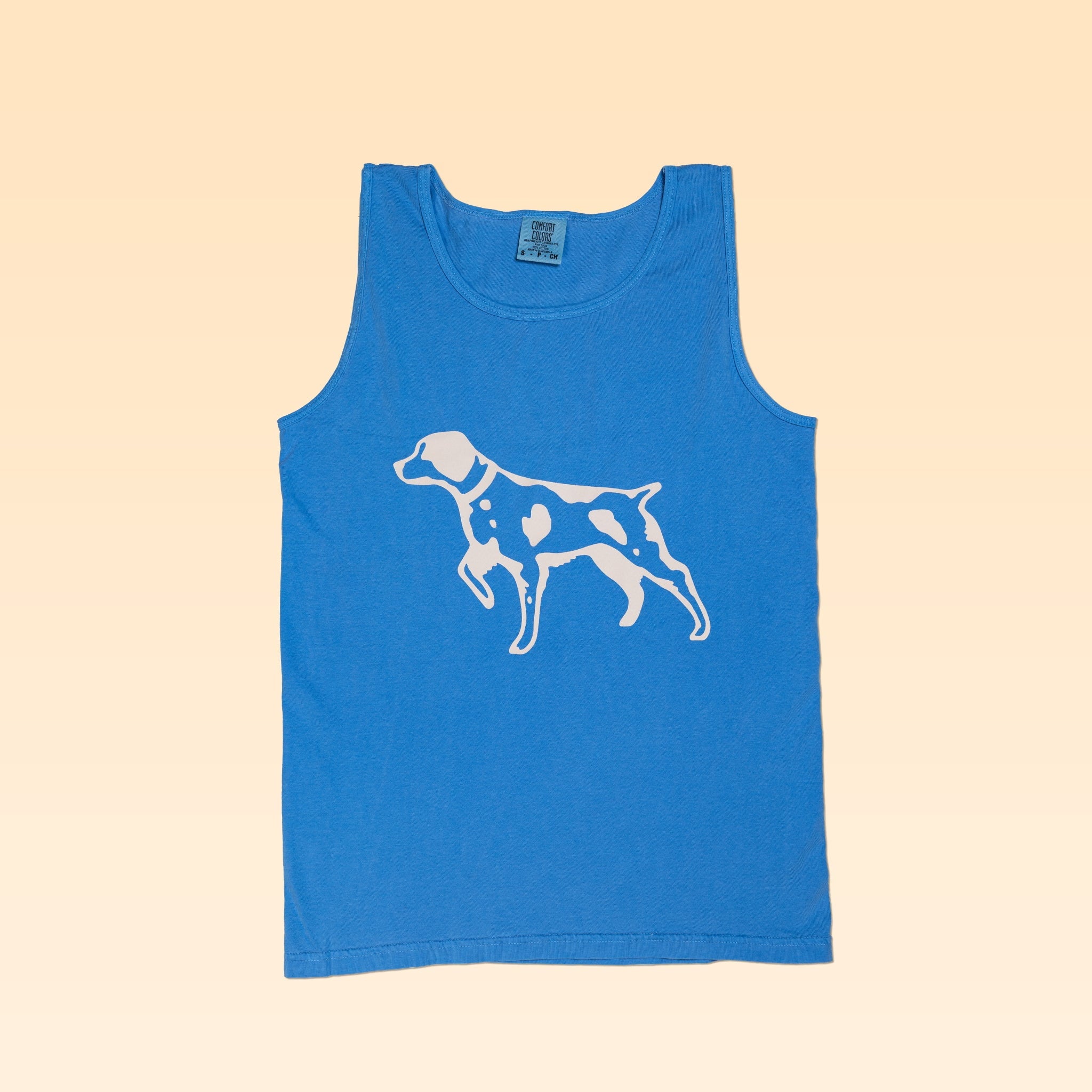The Shop Tank | Pointer from Ballad of the Bird Dog features a white spotted dog graphic on the front and is crafted from premium Comfort Colors fabric for extra softness. Displayed laid flat on a light beige background.