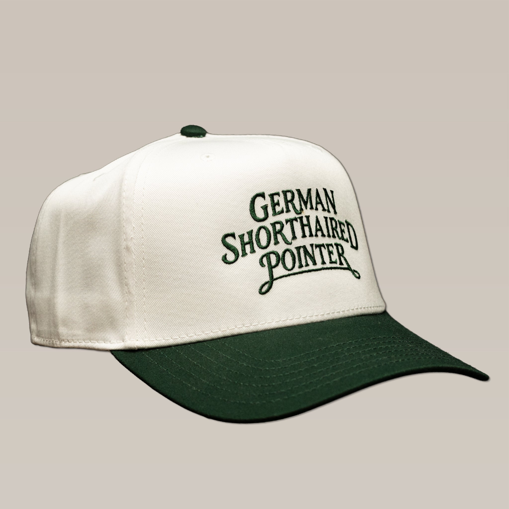 Ballad Originals Bird Dog Series Hat | German Shorthaired Pointer: a white baseball cap with a green brim and “German Shorthaired Pointer” embroidered in green.