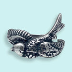 The Silver Sparrow Bird Ring by Ornamental Things features a bird in flight design, displayed against a light blue background.