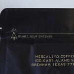 The Single Origin Whole Coffee Beans "Chelchele" by Mescalito Coffee comes in a black bag with "START YOUR ENGINES," the company address, and contains Ethiopian anaerobic natural processed medium roast beans.