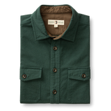 The Duck Head Slater Moleskin Overshirt in forest green features two chest pockets, dark brown buttons, and a branded label inside the collar for rugged style and durability.