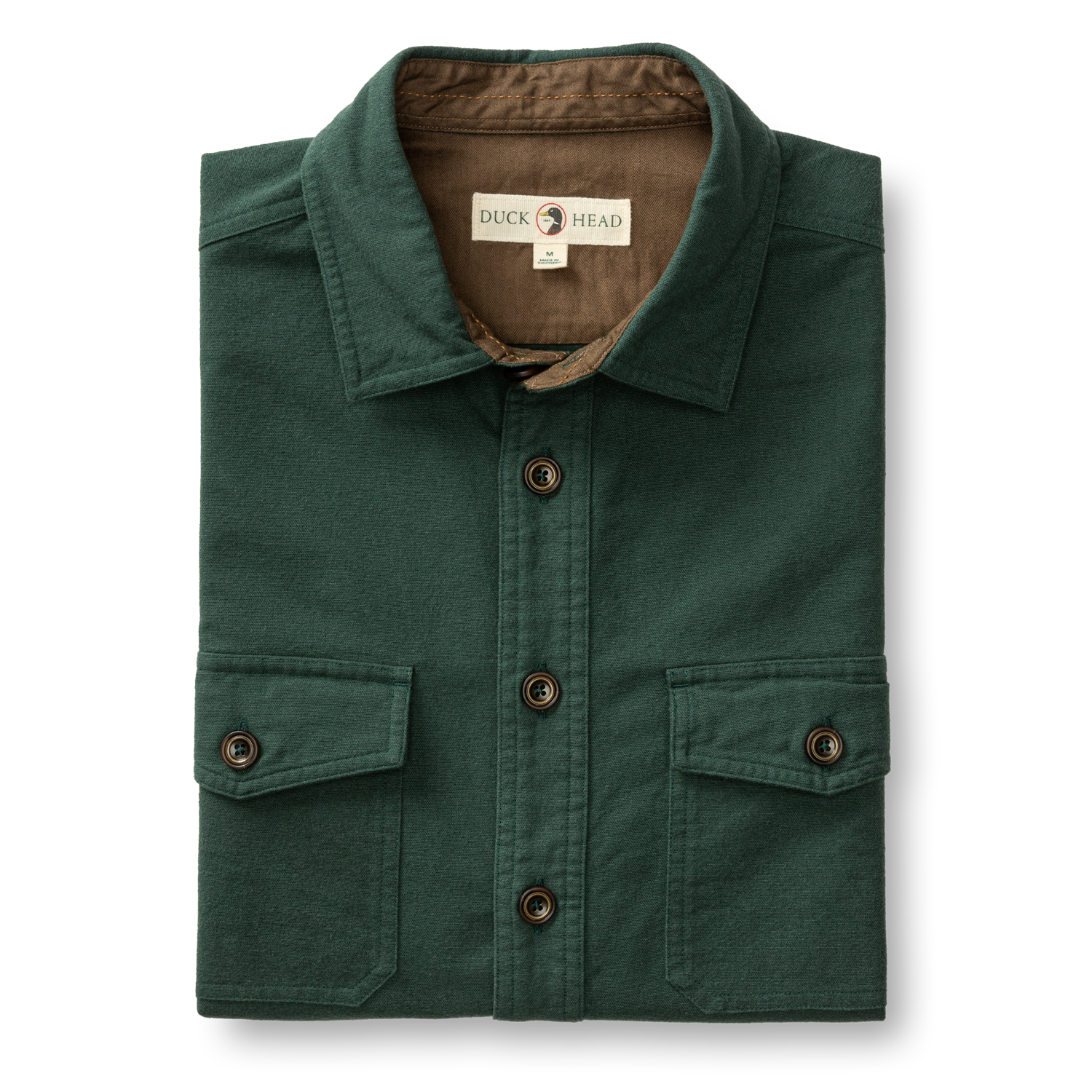 The Duck Head Slater Moleskin Overshirt in forest green features two chest pockets, dark brown buttons, and a branded label inside the collar for rugged style and durability.