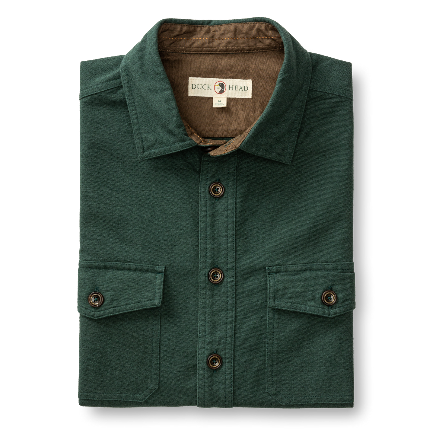 The Duck Head Slater Moleskin Overshirt in forest green features two chest pockets, dark brown buttons, and a branded label inside the collar for rugged style and durability.