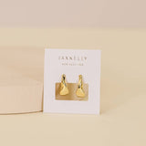 The Small Ripple Gold Hoop Earrings by JaxKelly are shown on a white JaxKelly card against a neutral background, highlighting these hypoallergenic and tarnish-free gold hoops.