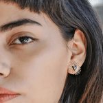 Close-up of a person wearing Peter and June's Sommar Layered Studs | Aventurine on their left ear, paired with delicate stone studs for a modern layered look.