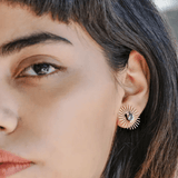 Close-up of a person wearing Peter and June's Sommar Layered Studs | Aventurine on their left ear, paired with delicate stone studs for a modern layered look.