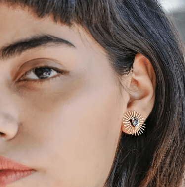 Close-up of a person wearing Peter and June's Sommar Layered Studs | Aventurine on their left ear, paired with delicate stone studs for a modern layered look.