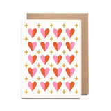 The Sparkly Heart Pattern Valentine Card by Worthwhile Paper features a pink and red heart design with gold stars, shown with a plain brown envelope in the background.
