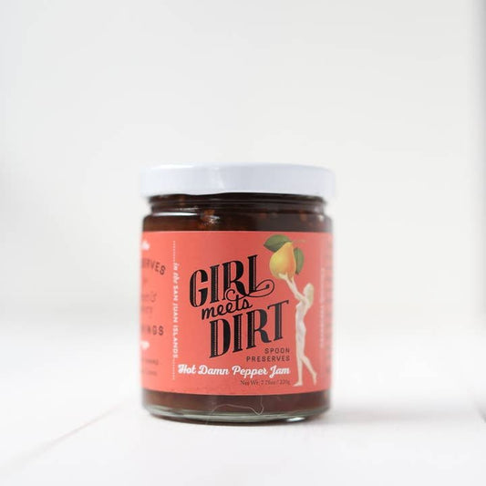 A jar of Spoon Preserves by Girl Meets Dirt features an artisanal organic fruit jam with a pink label showing a woman holding a peach.