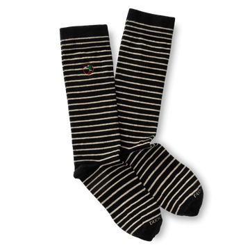 The Striped Logo Sock by Duck Head features black fabric with white horizontal stripes and a small embroidered Duck Head logo near the top, made in the USA.