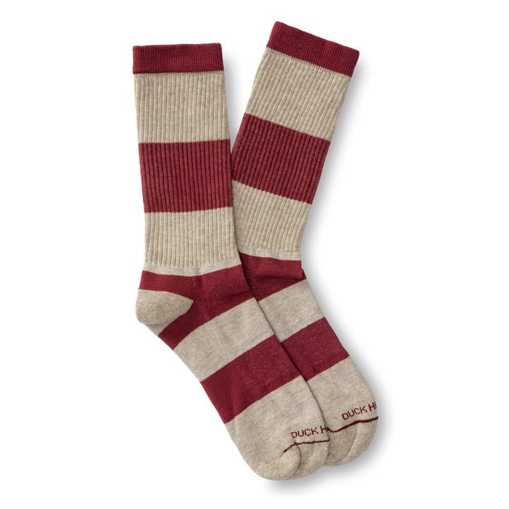 The Striped Ribbed Sock by Duck Head features wide red and beige stripes—ideal for pairing with boots on your next adventure.
