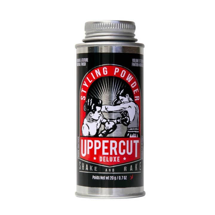 Uppercut Deluxe Styling Powder comes in a silver canister with a black and red label featuring two boxers, offering men a natural, matte finish for their hair.