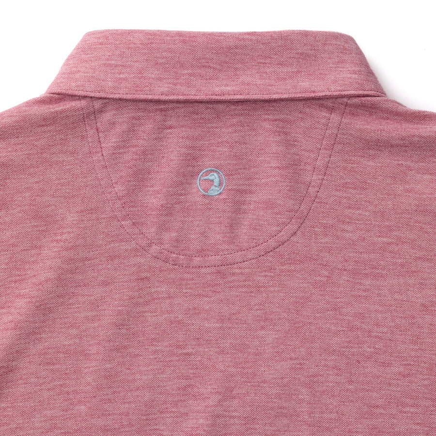 Back view of the Duck Head Summerford Performance Pique Polo in maroon, featuring a collar and a small light blue embroidered circular logo below the neckline.