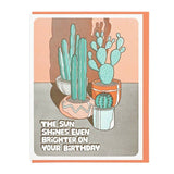 The Sun Shines Even Brighter card by Lucky Horse Press features three potted cacti with shadows and the message, “The sun shines even brighter on your birthday,” letterpress printed on the front.