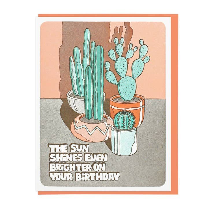 The Sun Shines Even Brighter card by Lucky Horse Press features three potted cacti with shadows and the message, “The sun shines even brighter on your birthday,” letterpress printed on the front.