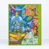 The Sunday Morning 1,000 Pieces puzzle by Birdie Puzzles features a vibrant illustration of birds, seashells, flowers, and a woman sitting among various objects.
