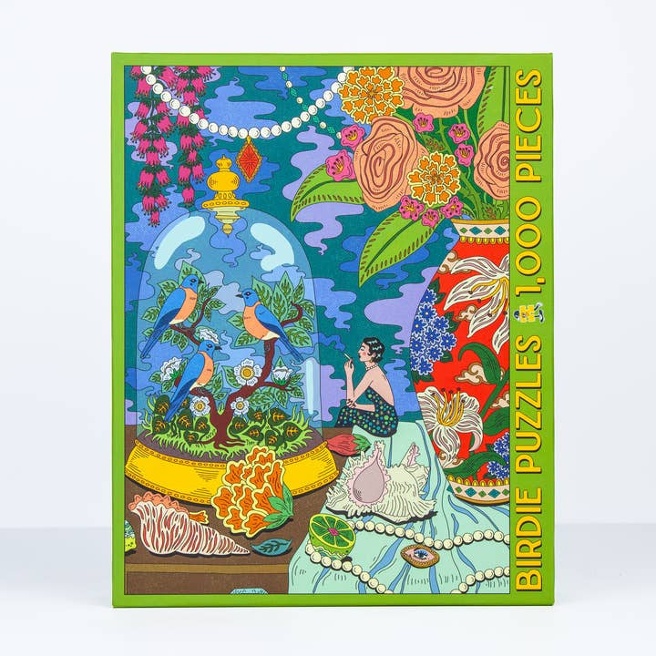 The Sunday Morning 1,000 Pieces jigsaw puzzle by Birdie Puzzles features vibrant artwork of birds in a glass dome, a seated figure, flowers, shells, and pearls—all crafted from recycled materials.