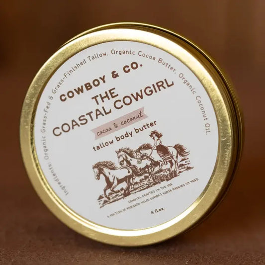 A round tin of Cowboy & Co. Tallow Hydrating Body Butter, featuring running horses and product details on the lid, made with grass-fed tallow—ideal for sensitive skin.