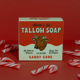 A box of Health y Sol Tallow Soap, all natural and candy cane scented, sits surrounded by candy canes on a red background.