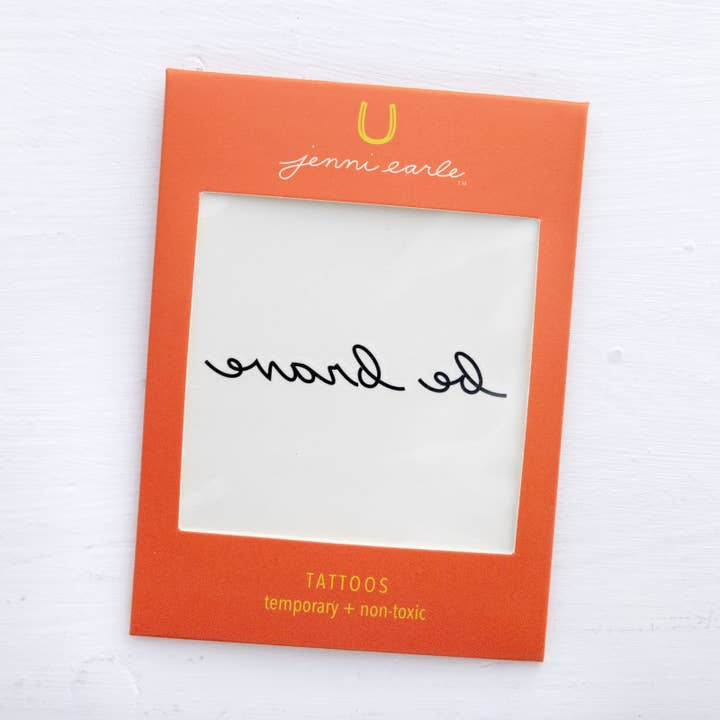 The Jenni Earle Temporary Tattoos feature the phrase "be brave" in black script (shown reversed). These non-toxic tattoos are safe, stylish, and a perfect way to add a touch of courage.