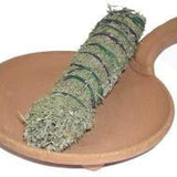 The Terracotta Smudge Bowl 6in by Taos Herb Co holds a bundle of dried sage, tied with string and resting on its round, brown clay surface with a convenient handle.