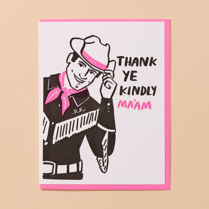 The "Thank Ye Kindly Ma'am" card by And Here We Are features a cartoon cowboy tipping his hat and "THANK YE KINDLY MA'AM" in black and pink—perfect as a western-themed thank you card for any occasion.