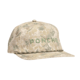 The Lone Range Hat by Poncho is a beige, floral-patterned 5-panel cotton trucker hat featuring green embroidered "PONCHO" text on the front and an adjustable snapback for comfort.