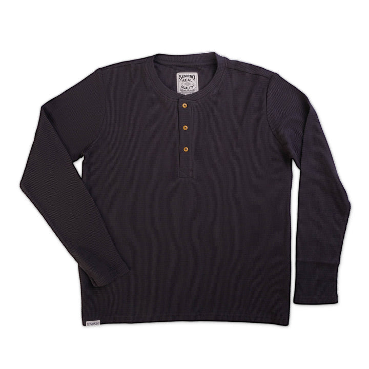 The Maverick Henley by Sendero Provisions Co. is a dark, long-sleeve waffle knit shirt with a three-button front placket, shown laid flat on a white background.