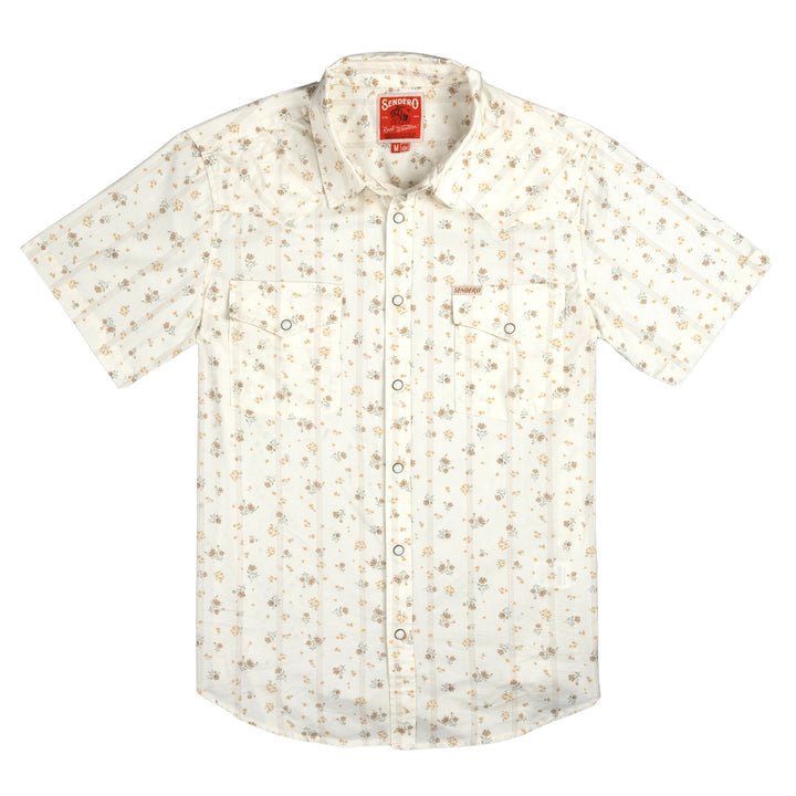 The Wyatt Pearl Snap Dustbloom by Sendero Provisions Co. is a cream short-sleeve western shirt with a small floral print, pearl snaps, button-up front, and two chest pockets.