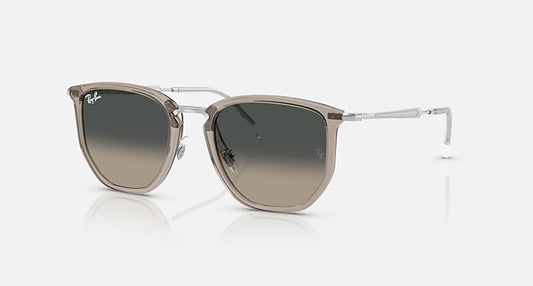 Transparent grey Ray-Ban sunglasses (RB4451) with square frames, metal temples, and grey gradient lenses shown on a light background.