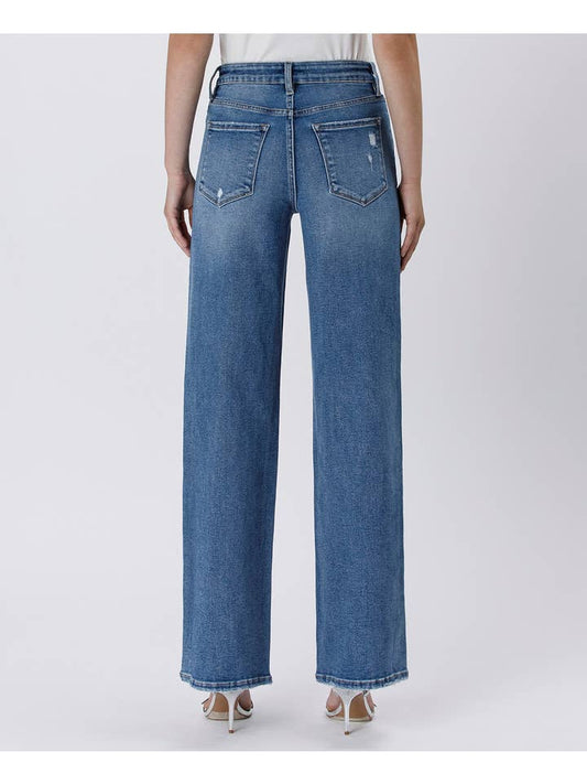 Model wears Vervet’s Tummy Control Super High Rise Baggy Wide Jeans, featuring back pockets and slight fading, shown from the back against a plain background.