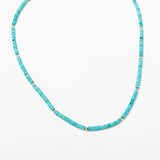 The Larissa Loden Turquoise Beaded Layering Necklace features turquoise-colored cylindrical beads and small gold spacers, shown on a white background.