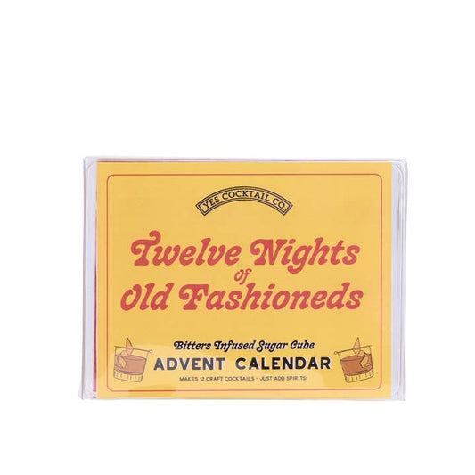 The Twelve Nights of Old Fashioneds from Yes Cocktail Co. is a yellow box Advent Calendar featuring unique bitters-infused sugar cubes for whiskey cocktail lovers—perfect for enjoying a new Old Fashioned each night.