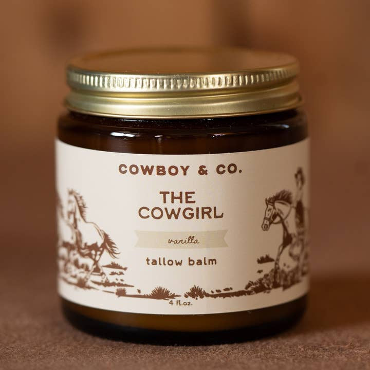 A 4 fl oz brown glass jar labeled "Cowboy & Co. Vanilla Infused Tallow Balm" with horse and rider illustrations on the label.