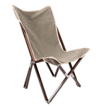 The Vaquero Chair by Chama Chairs features a brown wooden frame and beige fabric seat, displayed against a white background.