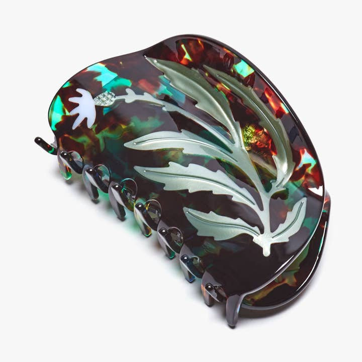 The Vervain Flower Herb Claw Clip by Winona Irene is an XL multicolored tortoiseshell hair accessory featuring a floral and leaf design, offering both style and protection for your hair.
