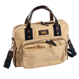 The Duck Head Waxed Canvas Laptop Bag features leather trim, dual top handles, a detachable shoulder strap, front zippered pocket, gold-tone hardware, and a trolley sleeve.