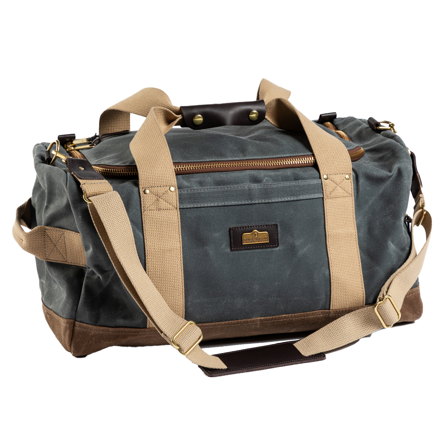 The Duck Head Waxed Canvas Overnighter Bag in charcoal features tan straps, gold-tone hardware, a front pocket, and a detachable shoulder strap. Made in the USA, it's your durable travel companion.