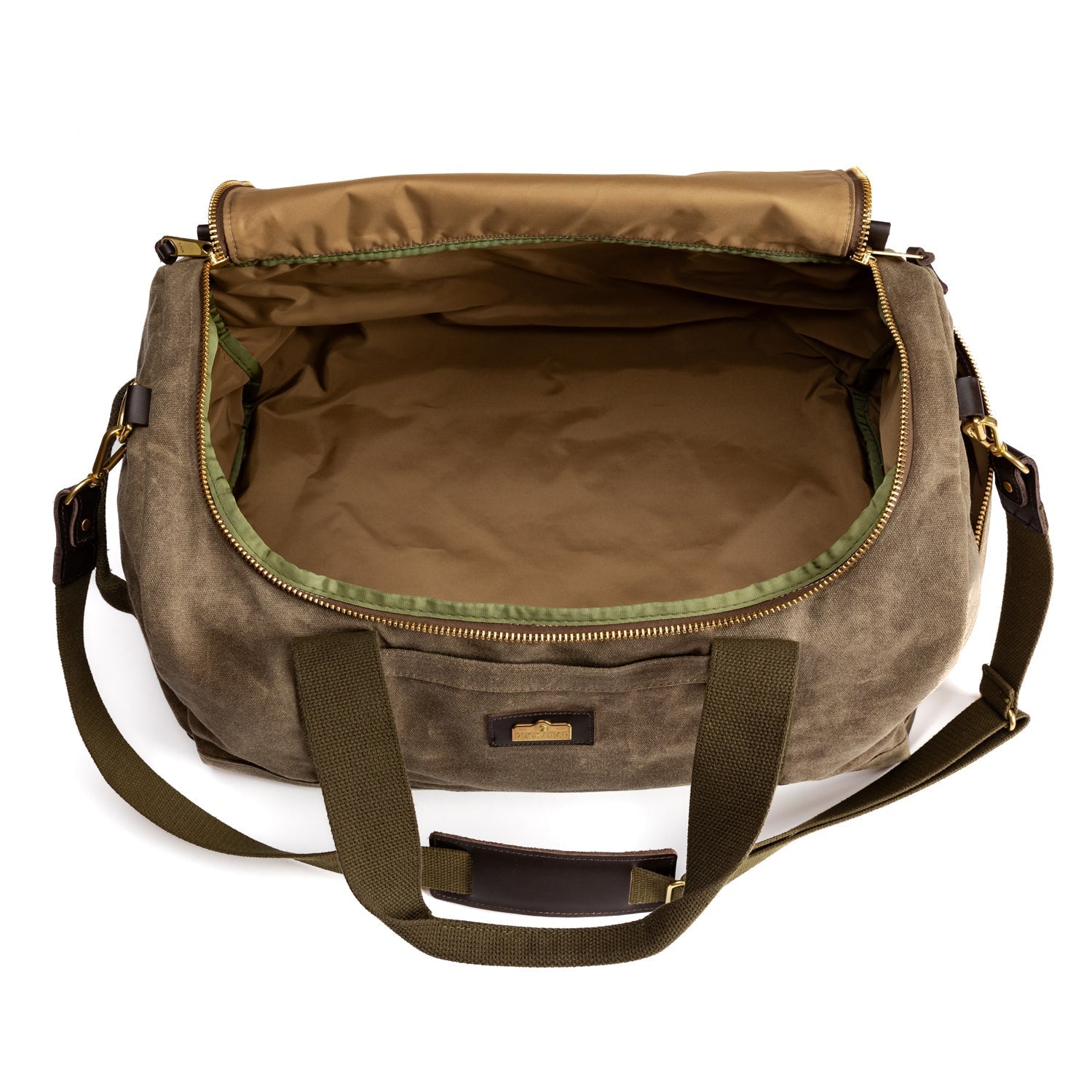 The Duck Head Waxed Canvas Overnighter Duffel in Field Brown with green trim, two handles, detachable shoulder strap, and top zipper is shown open and empty on a white background.