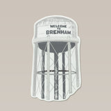 Show your local pride with the Shop Sticker | Welcome to Brenham Water Tower from Ballad of the Bird Dog—featuring a water tower illustration on a beige background. A unique, durable choice for custom sticker fans and Anvil Cards collectors.