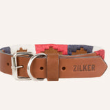 The Willie Dog Collar by Zilker Belts features hand-stitched brown leather, a silver buckle, and red, white, and blue embroidered fabric accents. "ZILKER" is embossed on the end for a stylish touch.