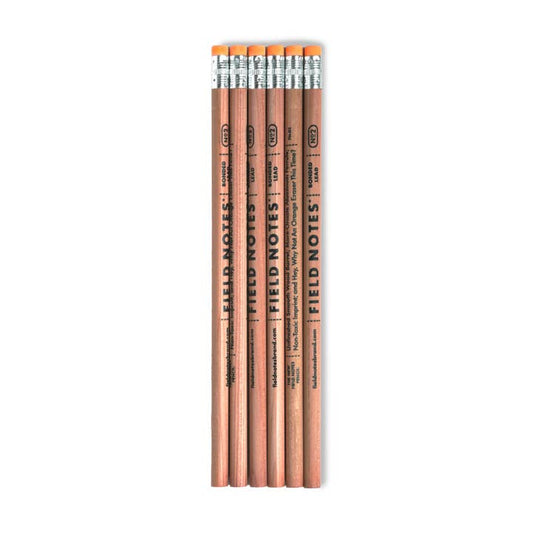 Six Woodgrain Pencils from Field Notes, each with a degradable eraser and recyclable aluminum ferrule, are laid out side by side on a white background.