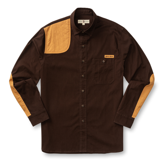 The Duck Head Woodland Shooting Shirt is a brown, stretch twill long-sleeve with tan quilted patches on the right shoulder, left chest pocket, and elbows, shown on a white background.