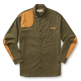 The Duck Head Woodland Shooting Shirt is an olive green long-sleeve top with tan quilted shoulder and elbow patches, a chest pocket, and button front, crafted from durable stretch twill outdoor fabric. Laid flat on a white background.