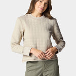 A person wearing the Duck Camp W's Cheyenne Quilted Crew in light beige and olive green pants stands against a plain light background.