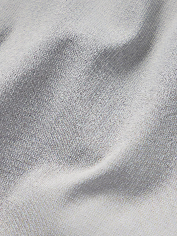 Close-up of the W's Gulf Pants by Duck Camp shows light grey, textured fabric with visible creases and subtle woven patterns.