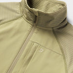 A close-up of Duck Camp’s W's Lightweight Grid Tech Fleece Half Zip in Sagebrush, featuring a high collar, chest zipper pocket, and textured grid fleece on the shoulders and inner collar.